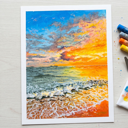 Handcrafted oil pastel painting of a beach sunset with thick textured waves and a vibrant orange and blue sky.